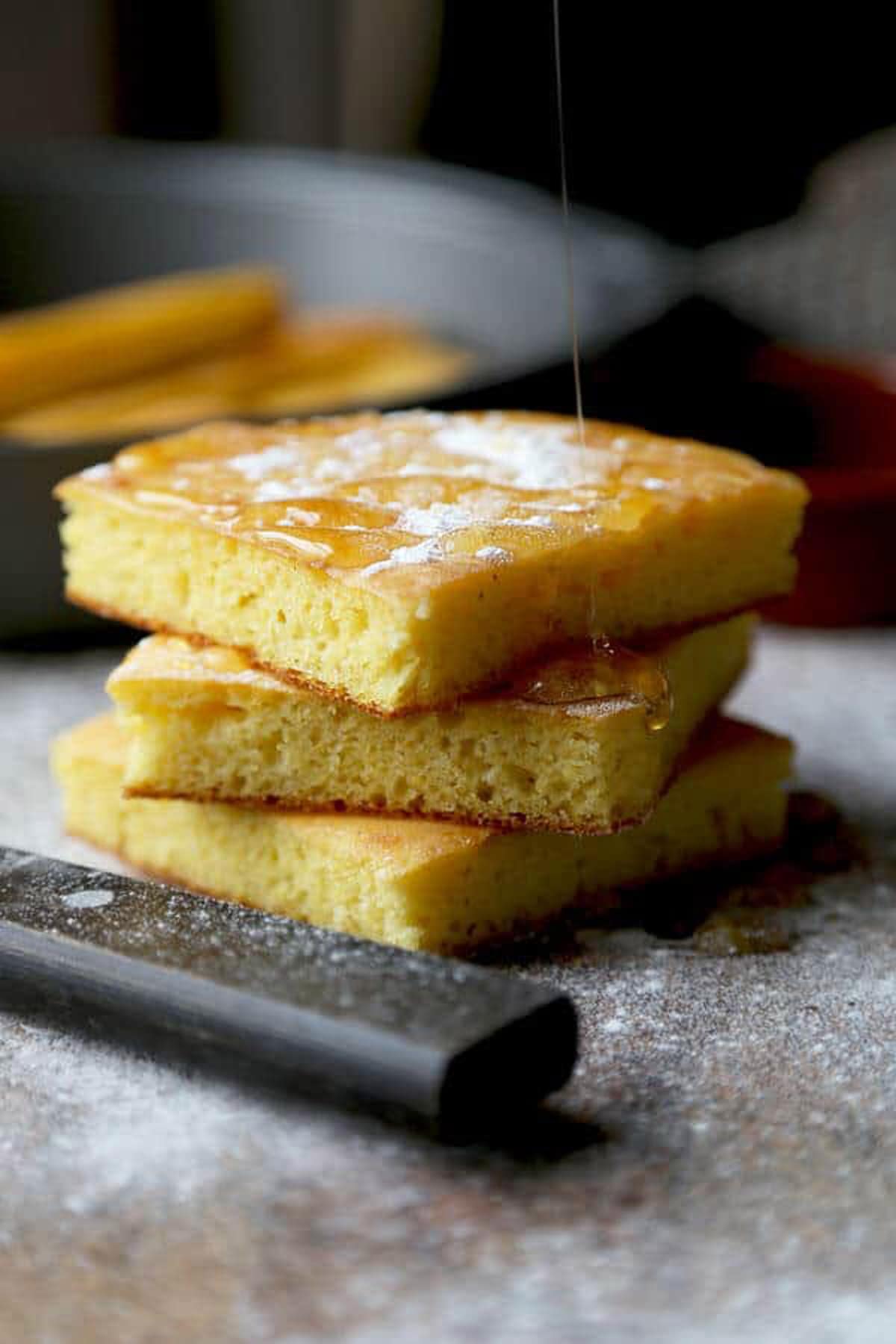 southern cornbread on a cutting board with a knife handle